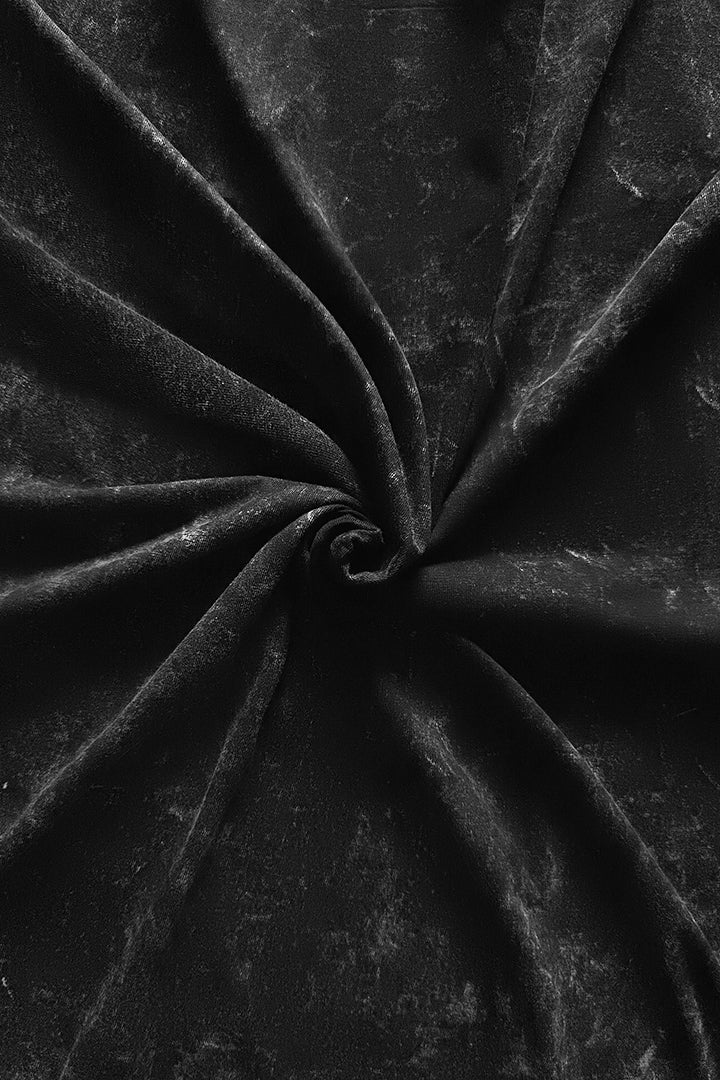 Close-up of black acid wash fabric with folds 