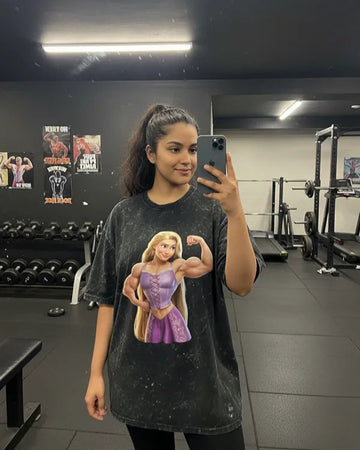 Person wearing Manmaker t-shirt with a graphic of a character in a gym setting